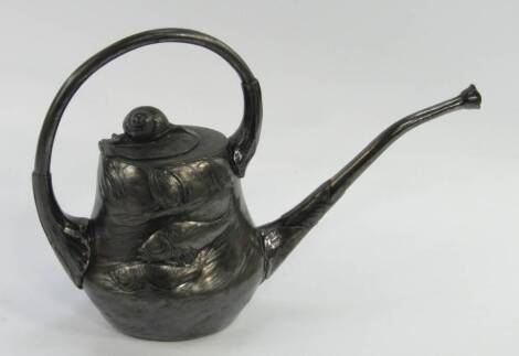 A Kayserzina Art Nouveau pewter watering can, designed by Albin Muller, the body decorated in relief with fish in a pond, spout with lily pads and the winged lid with snail finial, No 4205, circular mark, 22cm high, (AF).