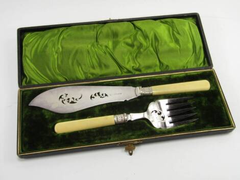 A pair of Victorian plated fish servers, with pierced and engraved floral decoration, ivory handles, cased.