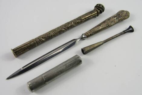 A silver cigarette holder, Birmingham 1960, trench lighter with engraved monogram, paper knife with King's pattern handle, and a silver container embossed with flowers, London 1905.