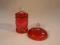 A Victorian cranberry glass barrel shaped jar and cover