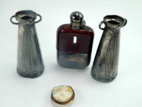 A pair of Jugendstil white metal vases, (AF), 11cm high, together with a leather bound plated hip flask and a cameo brooch bust portrait of a lady.