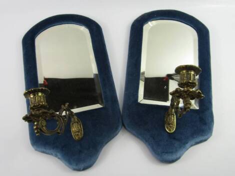 A pair of brass and blue velvet backed girandoles, inset bevelled glass, 41cm x 22cm.