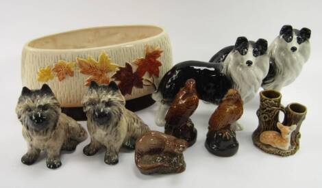 A pair of Sylvac pottery Cairn Terriers, No 3447, Sylvac oval vase moulded with leaves, No 4001, a pair of Melba Ware Collie dogs, three Beswick Beneagles whisky bottles, full, modelled as a seal, and two eagles, and a Sylvac fawn vase, No 4290, (9).