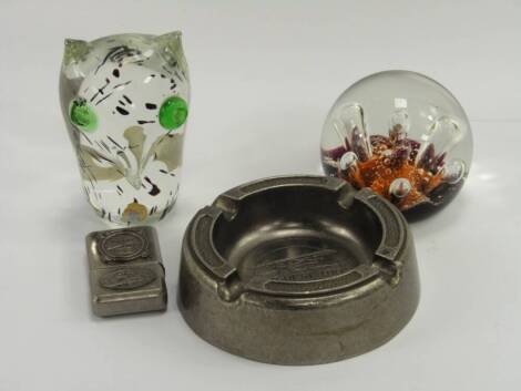 A Caithness Seadance paperweight, together with an owl paperweight and a Spirit of St Louis reproduction pocket lighter and ashtray, (4).