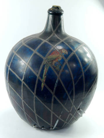 A large green glass bottle, with pewter strap work and painted with a parrot, 58cm high.