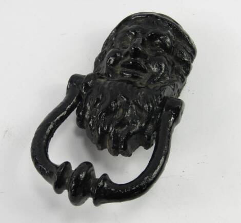 A Victorian black cast iron gnome door knocker, with a newspaper clipping illustrating a similar knocker to be found on doors of dwellings at Canal Street, Nottingham.