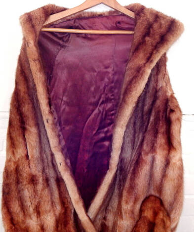 A full length fox fur coat, silk lined.