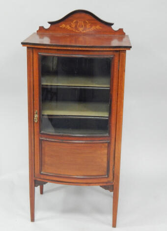 An Edwardian satinwood banded mahogany music cabinet, with glazed bow front door, 115cm x 45cm x 34cm.