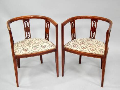 A pair of Edwardian string inlaid mahogany salon chairs, of open tub form