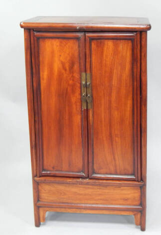 A Chinese hardwood cabinet, on turned legs, 68cm wide.