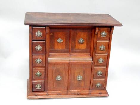 A late Victorian walnut cabinet, formerly a treadle sewing machine.