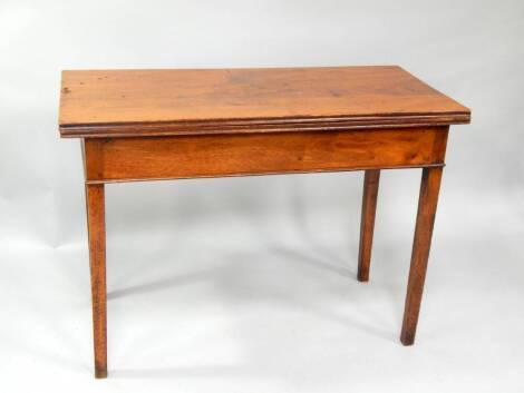 A George III mahogany tea table, with moulded rectangular folding top on square legs, 107cm wide