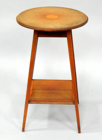 An Edwardian satinwood crossbanded mahogany occasional table, with circular shell inlaid top and undershelf, 43cm dia.