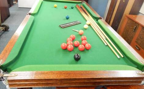 A half size snooker table, with balls.