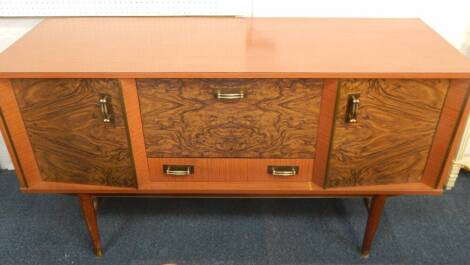 A 1960's Formica and faux walnut retro sideboard, incorporating cocktail cabinet, 138cm wide