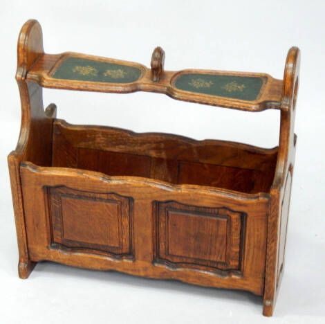 A mid 20thC oak magazine rack, with leather inset top.