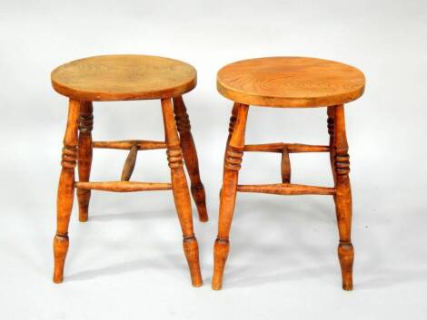 A pair of Victorian elm and beech stools, with three ring turned legs.