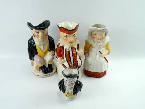 A pair of Punch and Judy character jugs, later 19thc, 24cm high, and two further character jugs modelled as John Bull, 4).