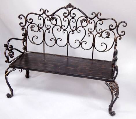 A wrought iron bench, 140cm wide.