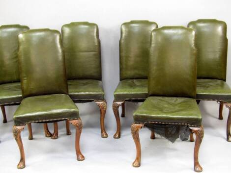 A set of six George I style walnut dining chairs, with studded leather backs and seats, with shell carved cabriole legs.