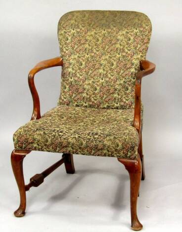 A George I style armchair, with crook arms and tapestry upholstery, on cabriole legs.