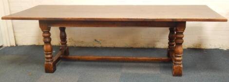 An oak refectory table, with turned baluster legs and plain H frame stretcher, 98cm x 255cm.