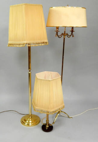 Two gilt brass standard lamps, and a table lamp, (3).