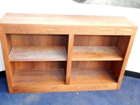 A walnut open bookcase, of four section form raised on a plinth base, 123cm wide.