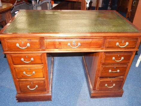 A Victorian walnut twin pedestal desk, the tooled green leather top over one long and eight short drawers, raised on plinth bases above castors, 106cm x 62.5cm x 75cm.