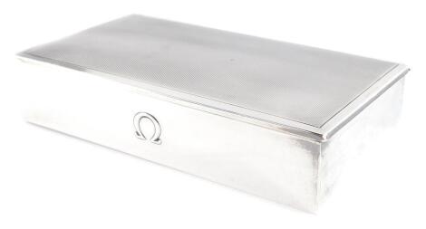 An Omega silver cigarette box, with engine turned decoration, stamped Tezler, 925, 3cm high, 15.5cm wide, 8.5cm deep, 8.37oz all in.