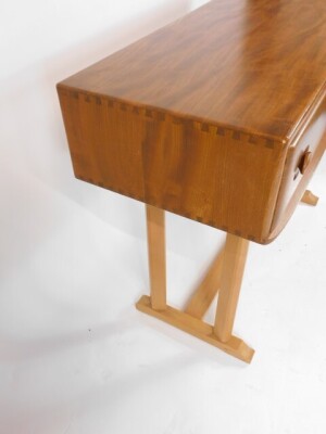 An Ercol blonde elm and beech side table, with two frieze drawers, raised on two pairs of chamfered supports, on an H frame base, 80cm high, 107cm wide, 45cm deep. - 3