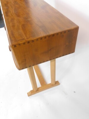 An Ercol blonde elm and beech side table, with two frieze drawers, raised on two pairs of chamfered supports, on an H frame base, 80cm high, 107cm wide, 45cm deep. - 4