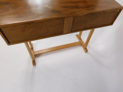 An Ercol blonde elm and beech side table, with two frieze drawers, raised on two pairs of chamfered supports, on an H frame base, 80cm high, 107cm wide, 45cm deep. - 5