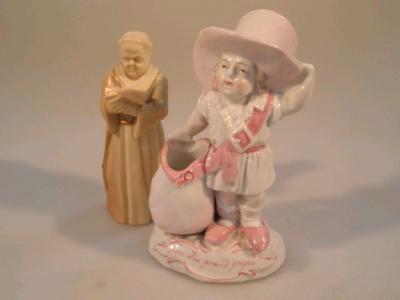 A late 19thC continental faring figure of a small child in a big hat and