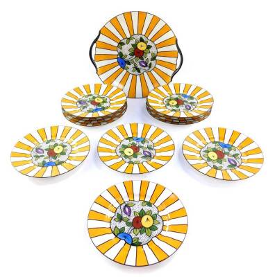 A Limoges early 20thC porcelain sandwich set, decorated with fruit within a sunburst border, printed mark, comprising twin handled dish and twelve plates.