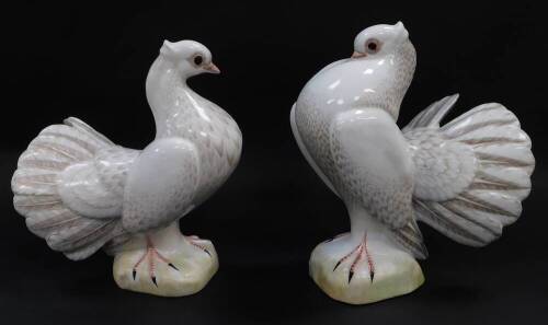 A pair of C Martinu porcelain figures of fantail doves, printed marks, 27cm and 26cm high respectively.