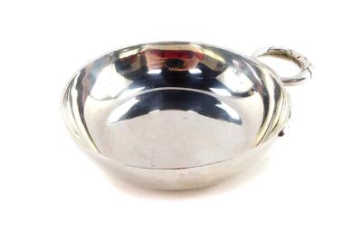 A silver wine taster, with a double cross over serpent handle, D & J Welby Ltd, London 1957, 1.95oz.