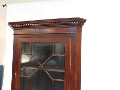 An Edwardian mahogany corner cabinet, the dentil moulded pediment over a glazed door opening to reveal two shelves, above a cupboard door raised on bracket feet, 198cm high, 80cm wide, 50cm deep. - 2