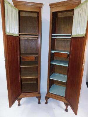A pair of Edwardian mahogany and inlaid wardrobe sections, each with an outswept pediment over a single door with glazed upper section, opening to reveal shelves and a single drawer, over leaf carved cabriole legs and ball and claw feet, 202cm high, 50cm - 7