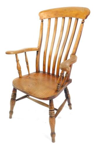 A Victorian beech oak and elm lath back kitchen chair, with solid saddle seat, raised on turned legs, united by an H frame stretcher.