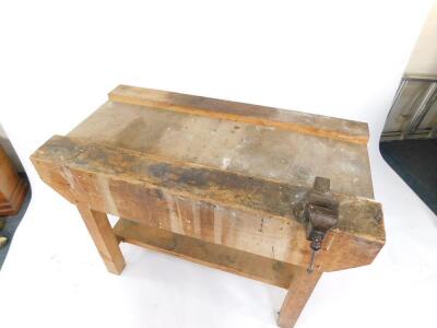 A pine work bench with a vice, and under tier, 84cm high, 122cm wide, 62.5cm deep. - 2
