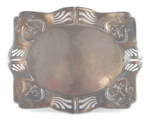 A Continental Art Nouveau pewter tray, of rectangular serpentine form, embossed with trailing fuchsias and pierced with flames, 43cm wide.