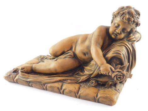 A Flemish late 19thC terracotta sculpture, of a naked child, recumbent on a sheet, with roses, on a naturalistic rectangular ground, bears signature, 25cm high, 39cm wide.