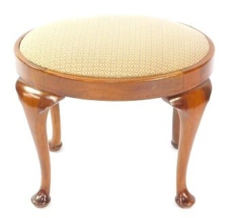 A Georgian style mahogany oval stool by J Hunter & Company Ltd, St Mary's Parsonage, Manchester., with a floral upholstered drop in seat, raised on cabriole legs.