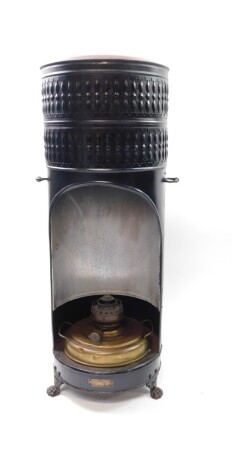 An Ardent Belgian early 20thC black tin and brass paraffin heater, of cylindrical form, raised on three paw feet, 80cm high, 30cm diameter.