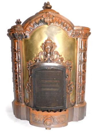 A French late 19thC cast iron and sheet metal fire by L Camus, of serpentine architectural form, cast with a mask head, rococo C scrolls and fluted columns entwined with foliate scrolls, 94cm high, 61.5cm wide, 33cm deep.