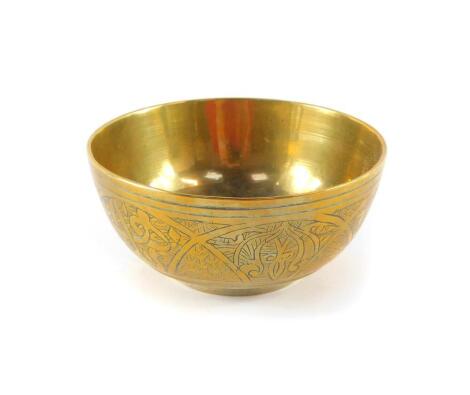 A Chinese polished bronze bowl, engraved externally with characters, 11cm diameter.