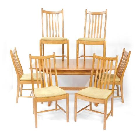 An Ercol ash dining suite, comprising a Windsor extending dining table, model 1193, 72cm high, 144cm wide, 194cm extended, 92cm deep., and six Windsor Penn single dining chairs. (7)