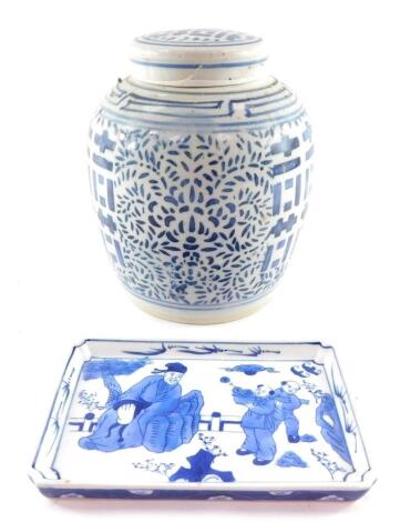 A Chinese Qing Dynasty blue and white ginger jar and cover, decorated in blue and white with symbols of happiness, peonies and scrolling leaves, 24cm high, together with a rectangular dish, decorated with figures in a garden, 21.5cm wide. (2)