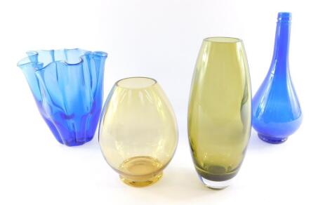 A Continental dark blue glass handkerchief type vase, 18cm high., a Riihimaki finish amber glass vase, 17.5cm high., green glass vase, 24cm high., and an Acqua della Madonna blue glass bottle, 26cm high. (4)